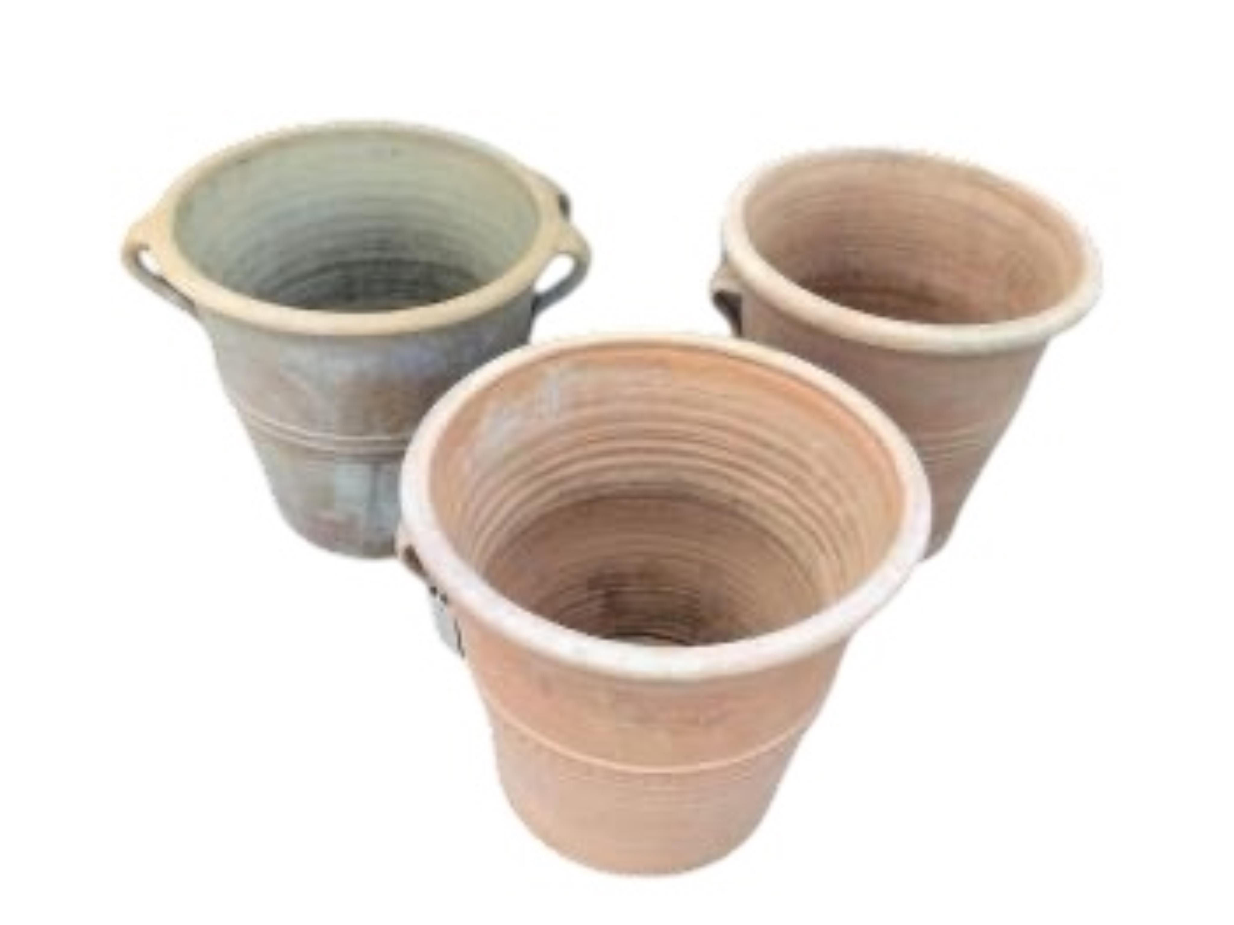Three circular terracotta garden planters, diameter 41cm, height 38cm